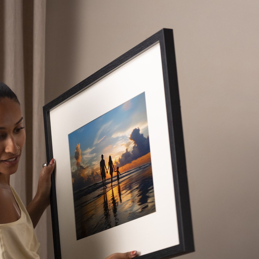 The Dahlia, a black frame being hung